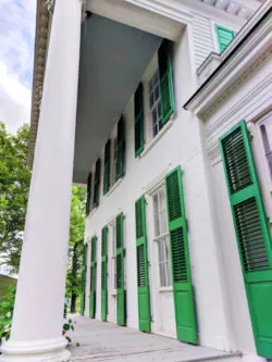 Green shutter front porch at masnion at Genesee Village Rochester New York 1