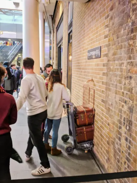 People Waiting for Pictures at Platform 9 34 in Kings Cross Station London 2