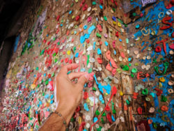 Putting gum on Post Alley Gum Wall Downtown Seattle 1