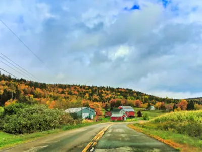 Red Barn and road with Fall Colors and clouds Pereaux Nova Scotia 1