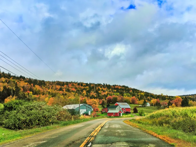Red Barn and road with Fall Colors and clouds Pereaux Nova Scotia 1