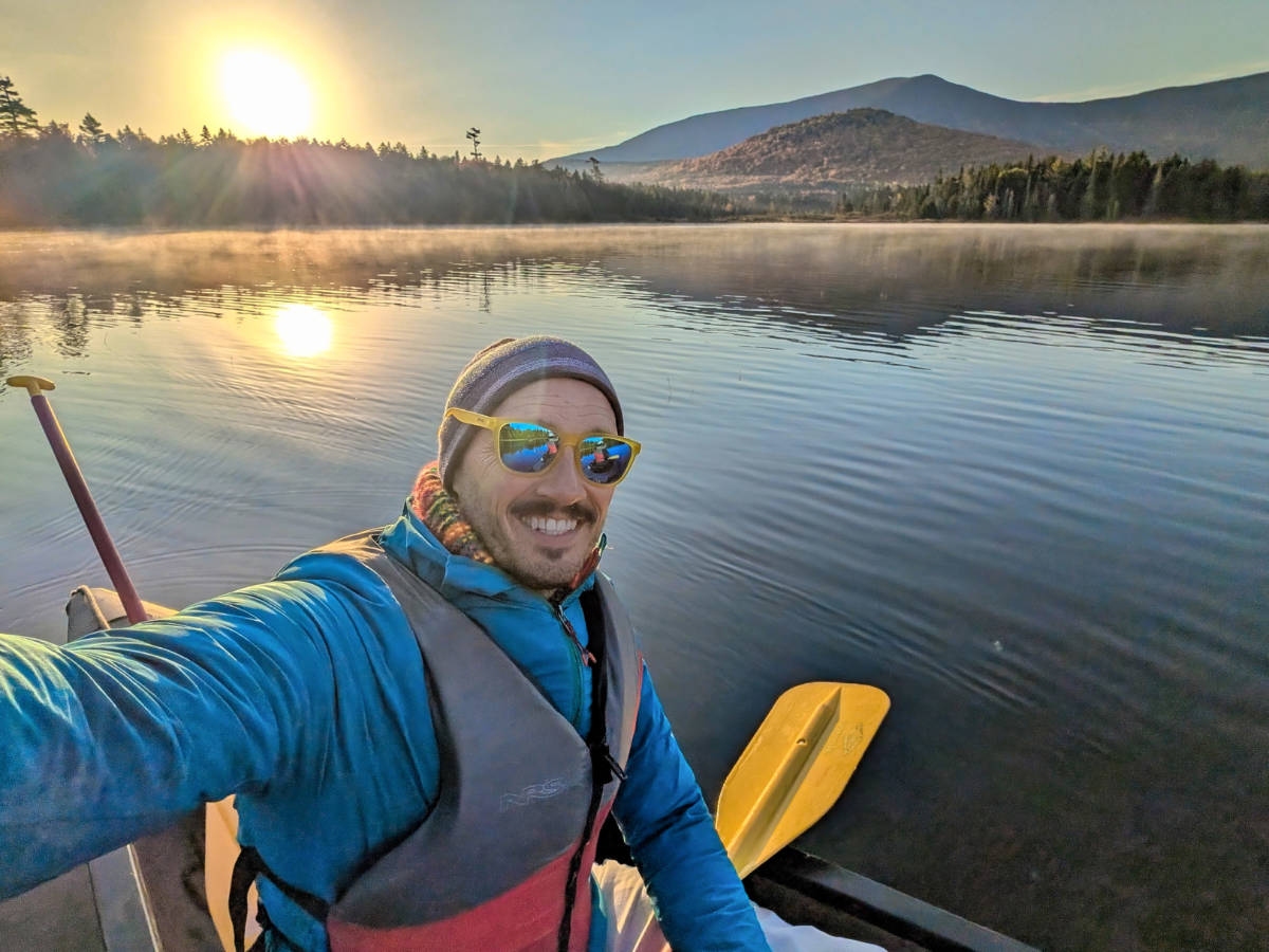 Rob Taylor with Fall Colors on pond with Northeast Whitewater Canoe Moose Tour from Greenville Maine