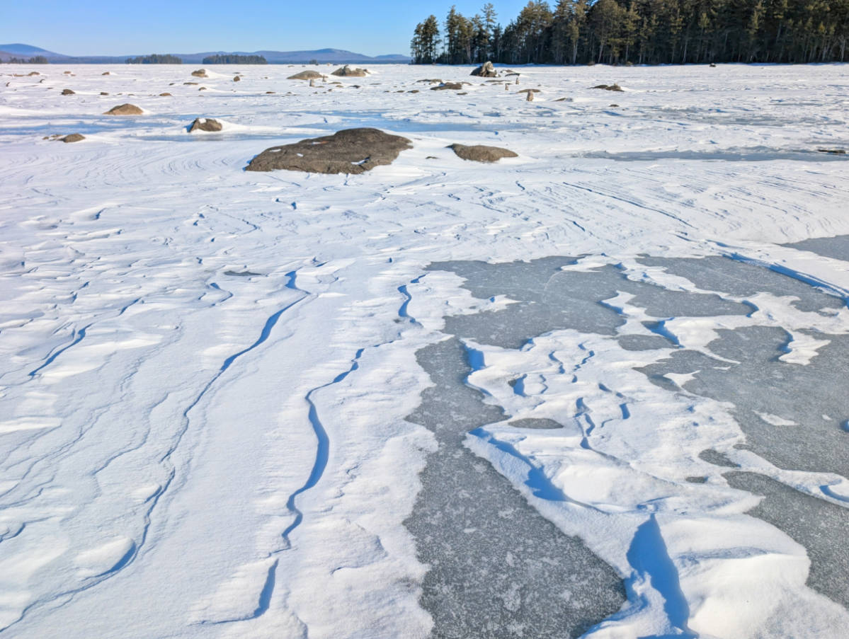 Snow drifts on frozen Millinocket Lake at NEOC New England Outdoor Center Maine 23