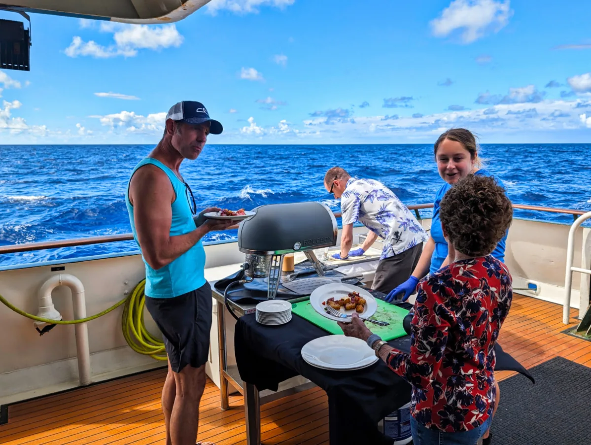 Taylor Family dining with BBQ on lower deck of UnCruise Safari Explorer Lanai Hawaii 1