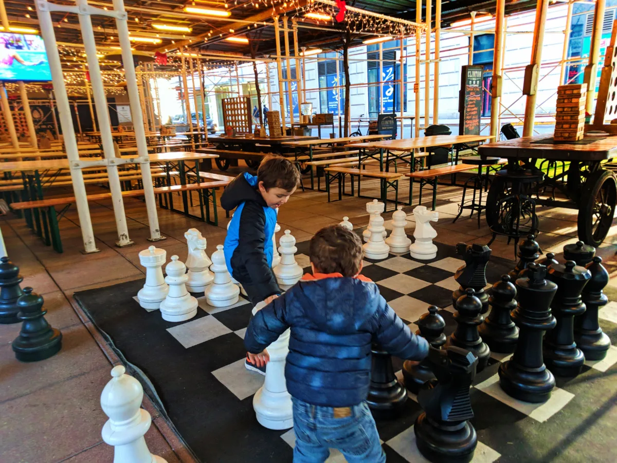 Taylor Family playing oversized chess at Clinton Hall Lower Manhattan NYC with kids 2