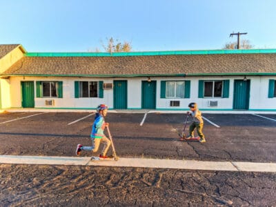 Taylor Family scootering at motel in Green River Utah cross country relocation 2020 3