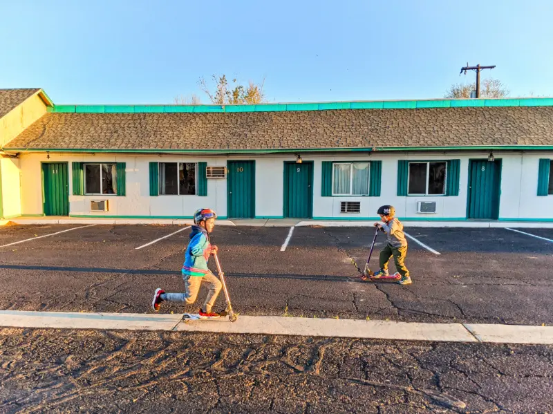 Taylor Family scootering at motel in Green River Utah cross country relocation 2020 3