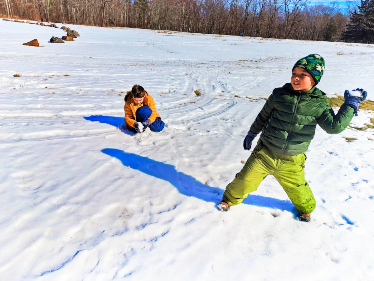 Taylor Family throwing snowballs in Camden Hills State Park Midcoast Maine 3