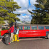 Taylor Family with Vintage Red Glacier National Park Tour Bus at Glacier Park Lodge East Glacier Montana 3