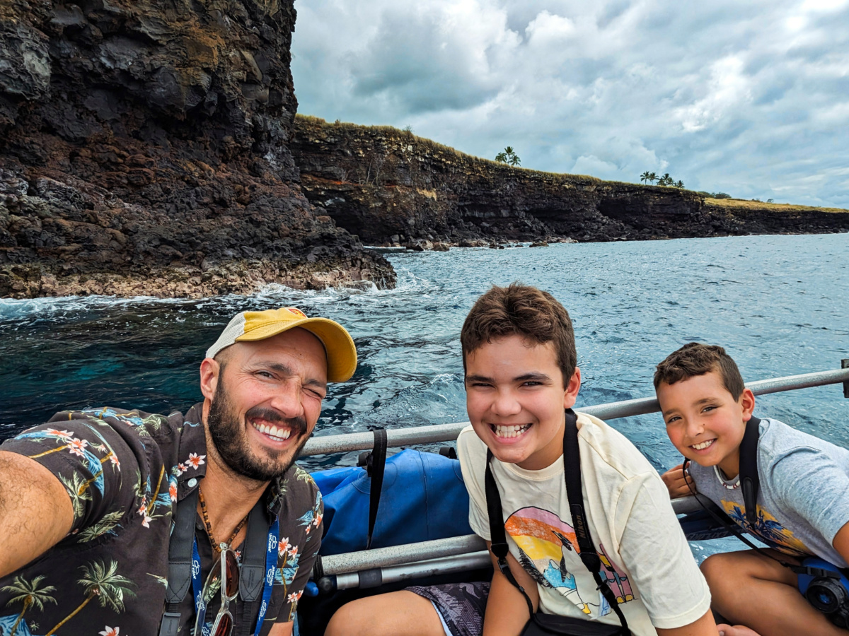 Taylor Family with Waves Crashing on Lava Cliff Kona Coast from Skiff with UnCruise Safari Explorer Big Island Hawaii 1