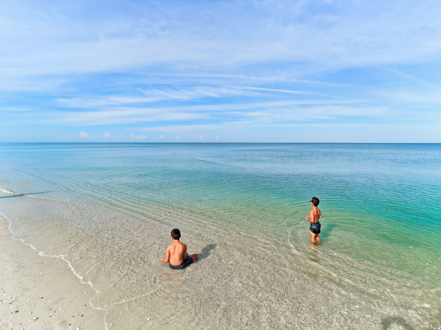 Taylor Family with manatee at Beach at Naples Grande Beach Resort Naples Florida 2